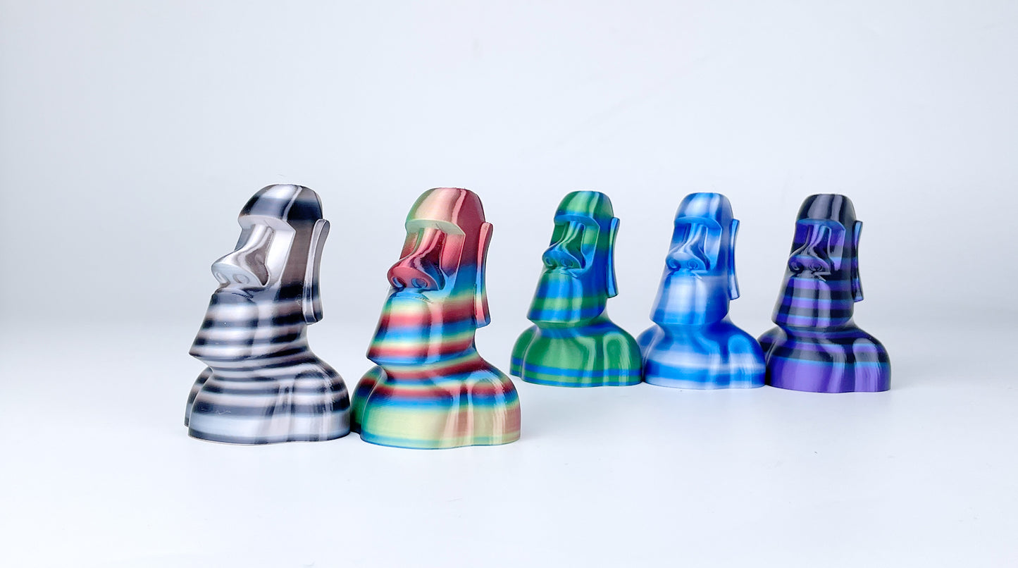 Five Moai statue models 3D printed with EIBOS Artism Series II Ribbons PLA filament in a range of striped colour combinations.