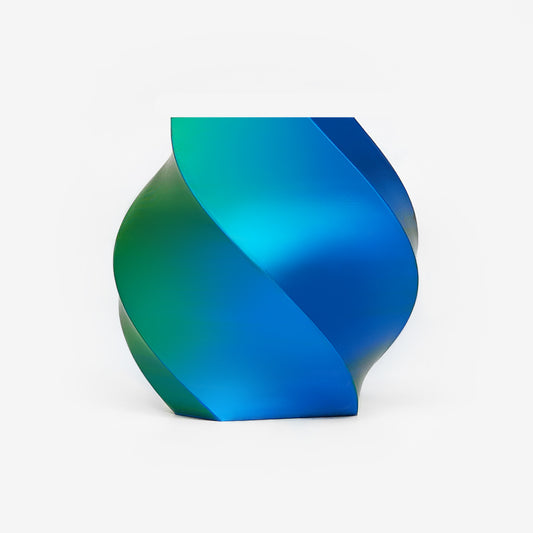 Twisted vase 3D printed with EIBOS Silk Series Blue–Green dual-colour PLA filament, showing its glossy colour-changing finish.