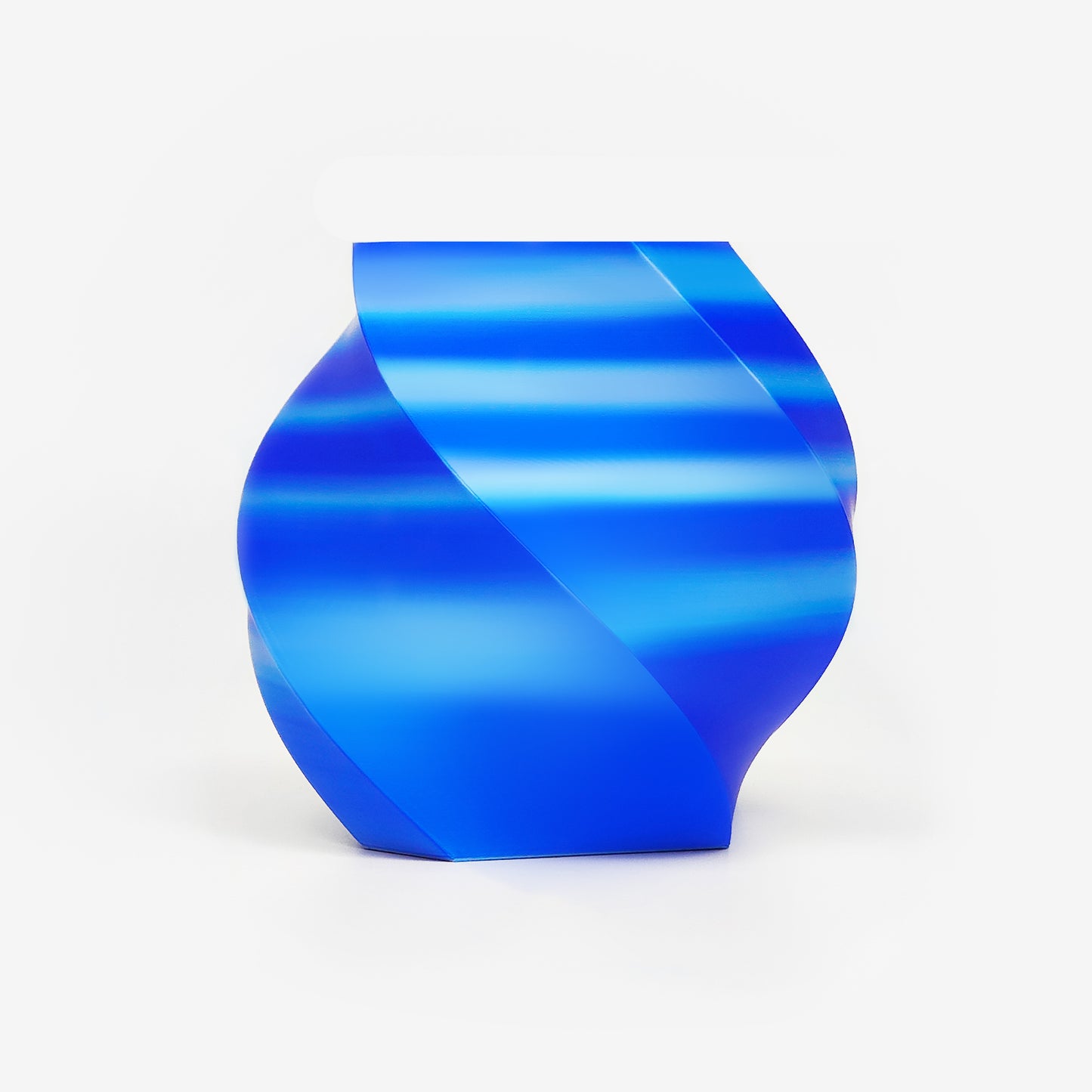 Twisted vase 3D printed with EIBOS Artism Series II Ribbons PLA in blue, silver and white, showing its glossy striped silk finish.