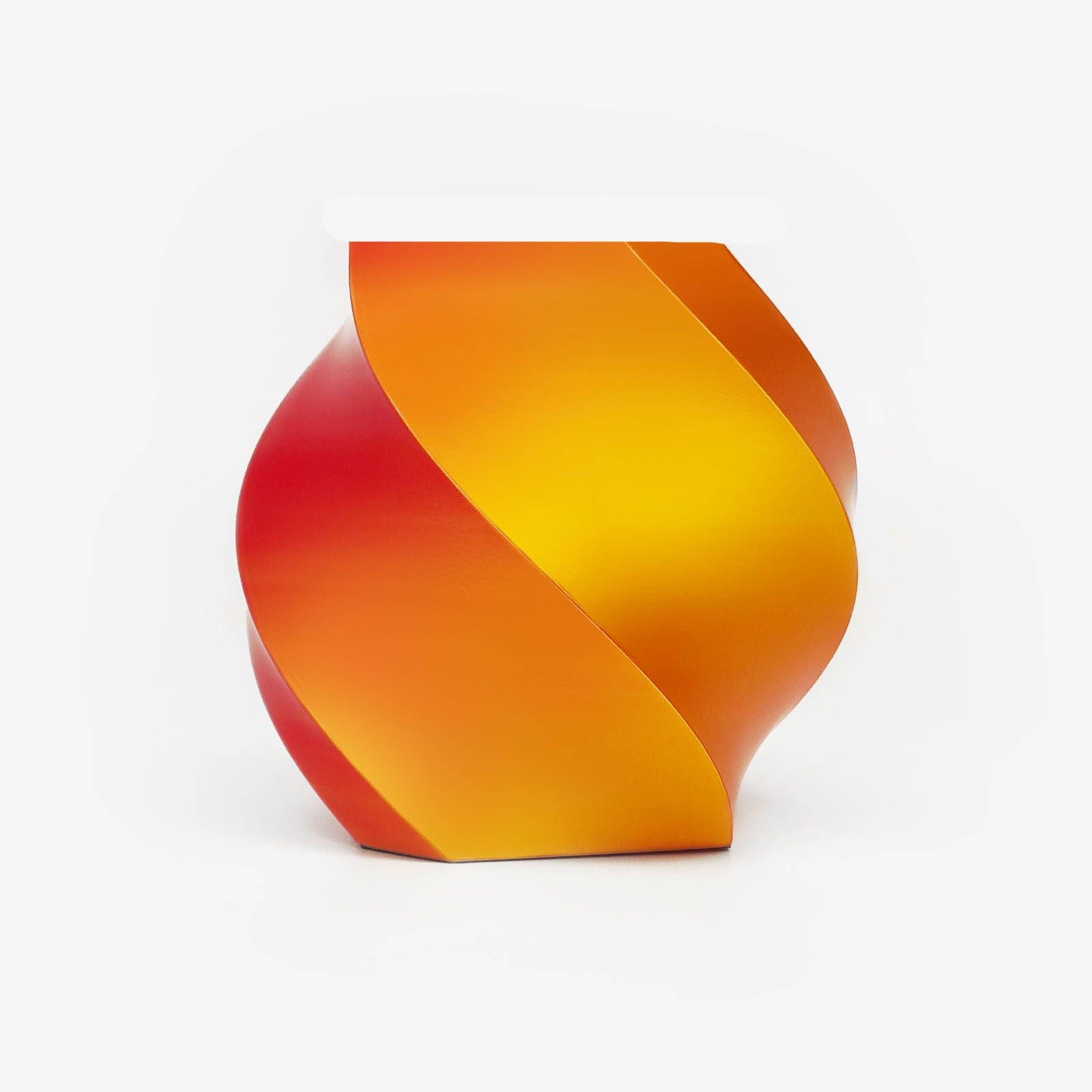 Twisted vase 3D printed with EIBOS Silk Series Gold–Red dual-colour PLA filament, showing its glossy colour-changing finish.