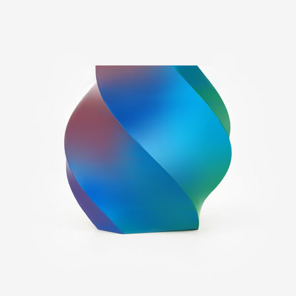 Twisted vase 3D printed with EIBOS Silk Series red, green and blue tri-colour PLA filament, showing its smooth colour-changing silk finish.