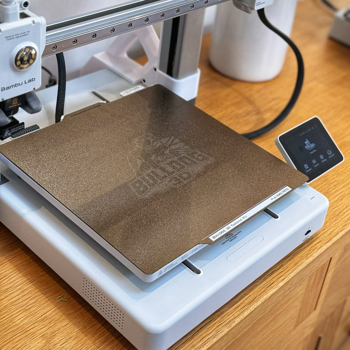 Angled view of Bulldog-3D textured PEI build plate installed on a Bambu Lab A1